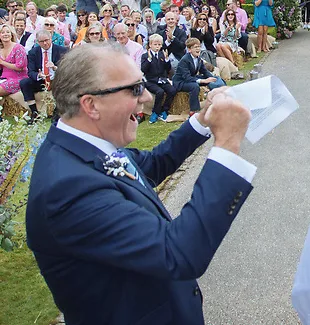 Jeremy Broughton celebrating in front of wedding guests